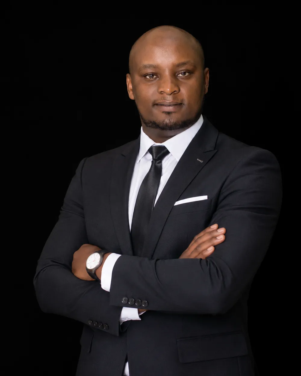 Ken Murithi, founder and lead developer of Ken Designers, in a black suit